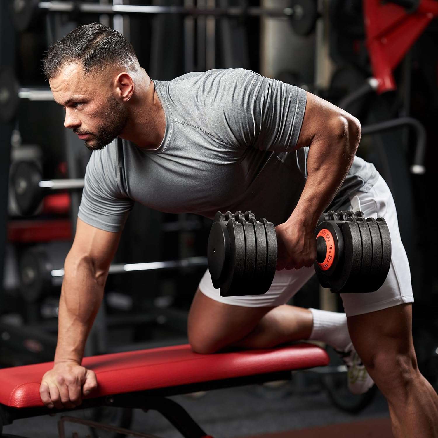 Man performing dumbbell row with adjustable 55LB dumbbell in gym