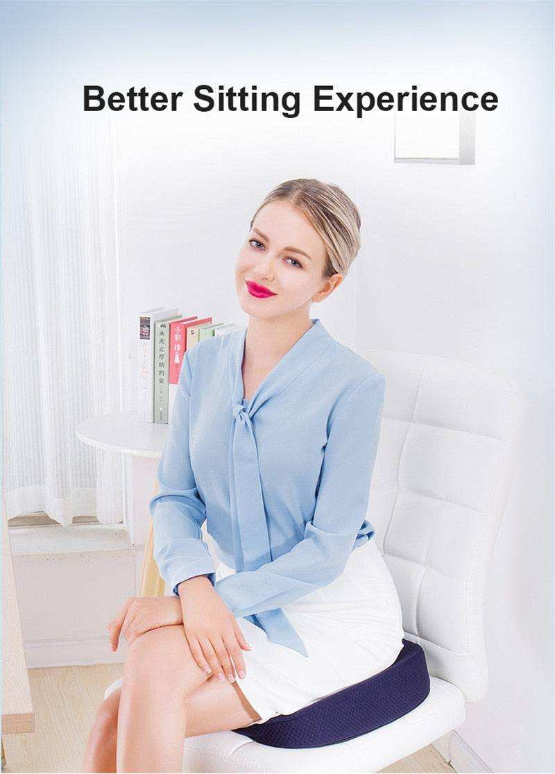 Woman using orthopedic seat cushion for better sitting experience on white chair