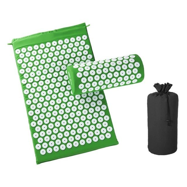 Green acupressure cushion and massage mat set with white plastic spikes and black storage bag for natural pain relief