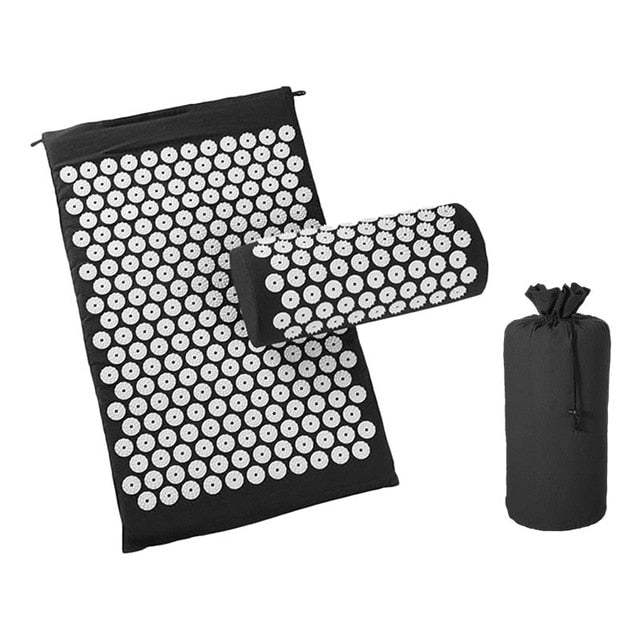 Black acupressure cushion and massage mat set with white plastic spikes and carrying pouch for natural pain relief and muscle relaxation